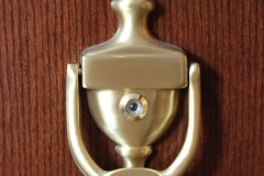 Golden door knocker on wooden door at The Inn at Ohio Northern University in Ada, OH