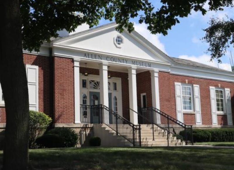 Entrance to Allen County Museum brick building with stairs near trees and green lawn near The Inn at Ohio Northern University in Ada, OH