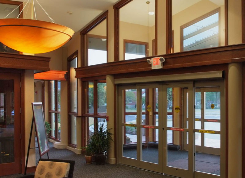 Entrance to The Inn at Ohio Northern University in Ada, OH with hanging lights near poster and chairs